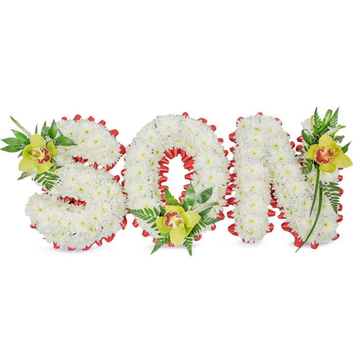 A lovingly made memorial display spells the word SON in bold, sculptural letters, each letter built from dense clusters of small, pristine white chrysanthemum blooms that together create a cloud-like, tactile surface. The entire outline of each letter is edged with a continuous band of vibrant red ribbon folded into small scalloped loops-this red trim frames the white faces and the interior of the 'O', offering a vivid, solemn accent that reads as affection and courage. Placed with deliberate rhythm, three lime-green Cymbidium orchids-each with soft yellow-green petals and a distinctive reddish-brown throat-sit at the upper left of the S, the inner base of the O, and the upper right of the N. The orchids' waxy texture and quiet fragrance are set against an array of lush green leaves and fine fern fronds that trail and uplift the letters, lending a natural height and a sense of life to the composition. Soft, even lighting reveals subtle shadows between petals and ribbon, highlighting the meticulous handwork and the arrangement's structural integrity for use at funerals or gravesides. The white backdrop keeps the focus on texture and tone, and the overall mood is one of solemn dignity tempered with warmth. As a local florist familiar with families across Beckton, Gallions Reach and the surrounding East London neighbourhoods, I craft these tributes to balance longevity, tasteful symbolism and gentle beauty for those saying goodbye.